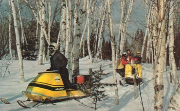 Featured is a c 1960 postcard image of snowmobilers in Maine.  The original unused postcard (featuring a skidoo snowmobile) is for sale in The unltd.com Store.